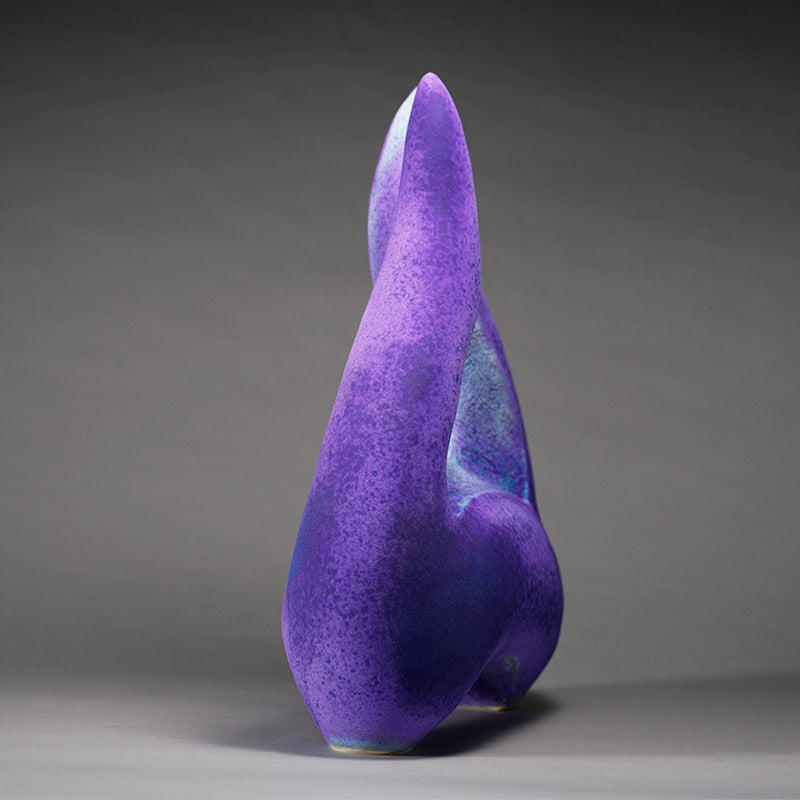 Side view of Aneela Dias-D'Sousa's hand built stoneware sculpture with bright rich purple matte glaze surface 