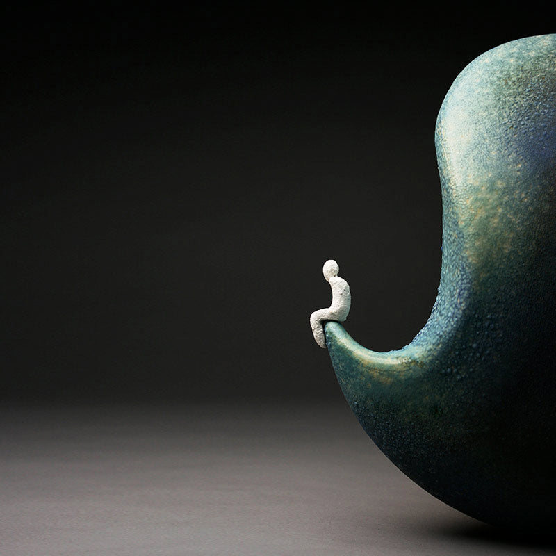Aneela Dias D'Sousa detail of large hand built Ceramic sculpture in matt blue and green with small man at tip